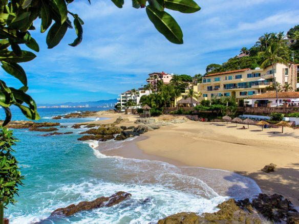 Beachfront condos along Conchas Chinas beach in Puerto Vallarta, showcasing ocean views and luxury real estate