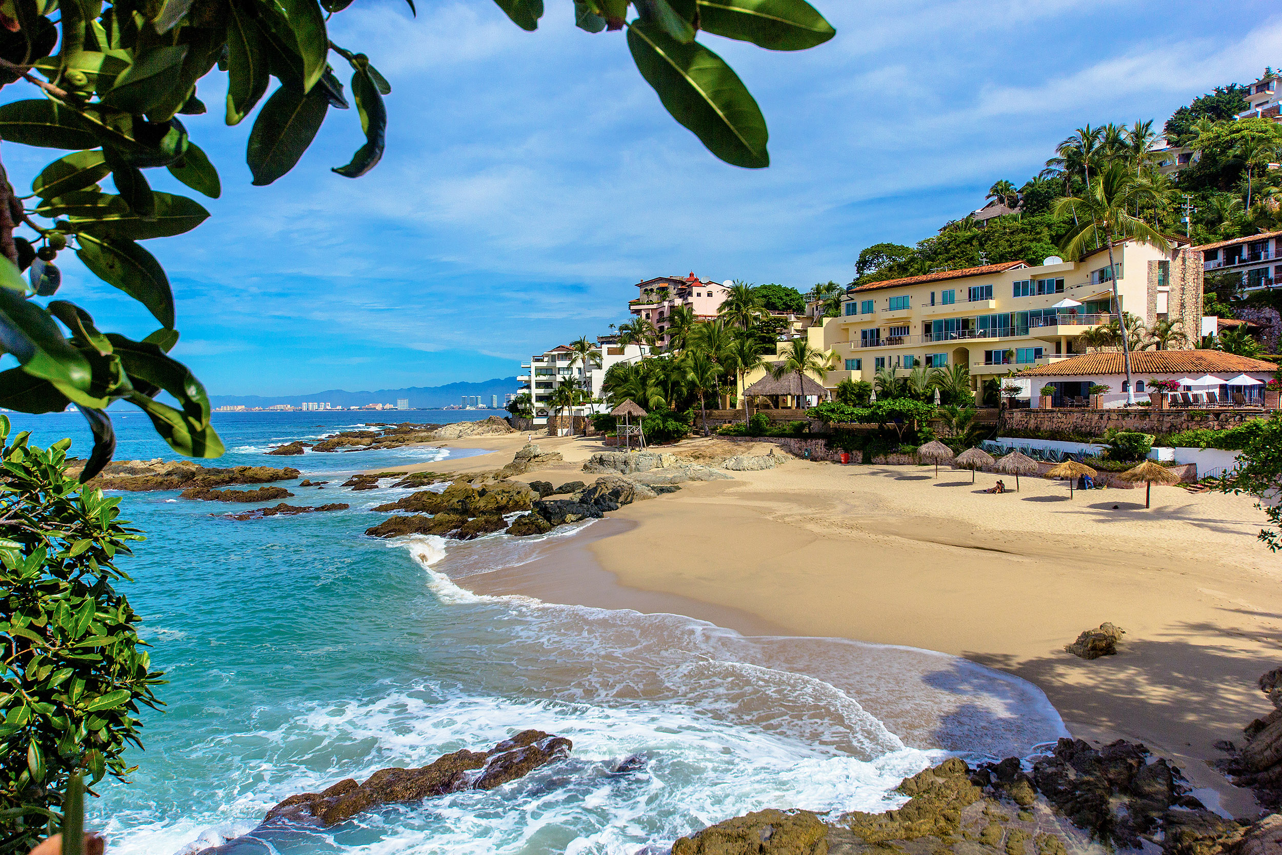 Beachfront condos along Conchas Chinas beach in Puerto Vallarta, showcasing ocean views and luxury real estate