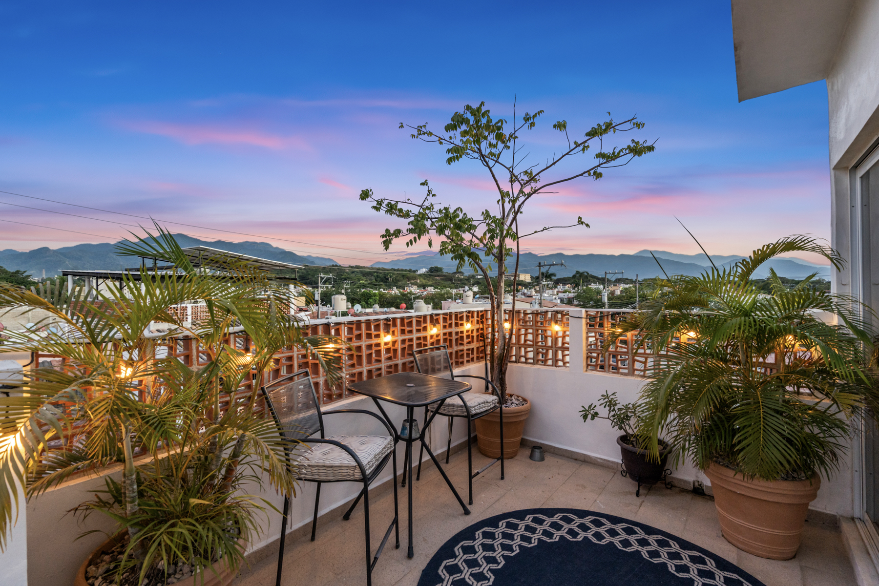 View from patio of El Santuario, a three level Puerto Vallarta home featuring terraces, modern finishes, and mountain views.
