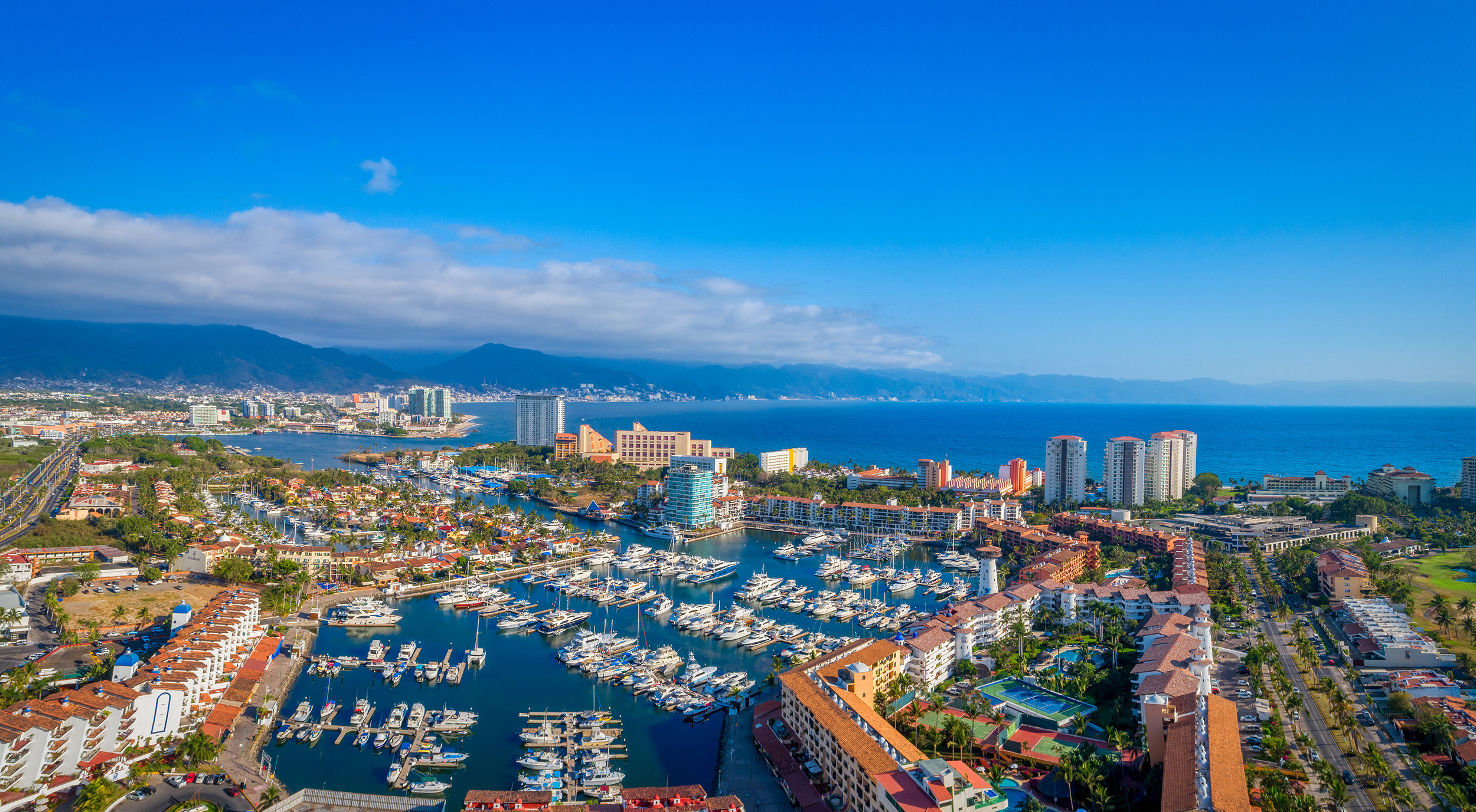 View of Marina Vallarta near Nima Bay condos, featuring yachts, restaurants, and oceanfront lifestyle in Puerto Vallarta