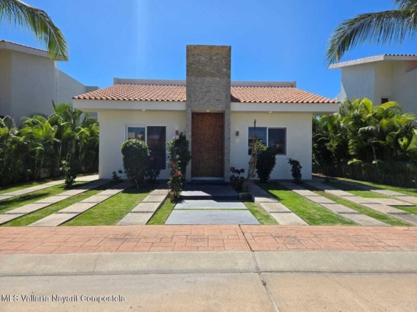 Modern 4-bedroom home for sale in Los Tigres, Nuevo Vallarta with garden and terrace views.